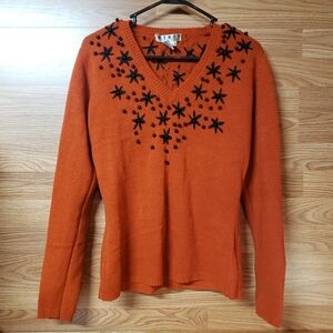 Elegant V-Neck Sweater in Orange with Black Star Details